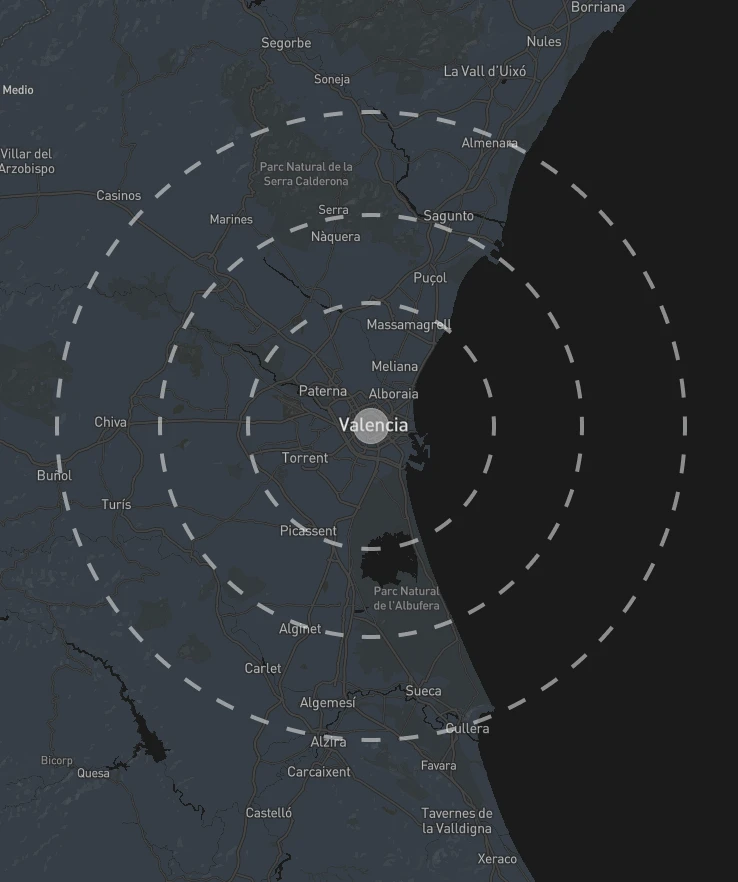 Map of Valencia and surrounding region in Spain showing concentric dashed circles indicating service area. Valencia is marked at the center with nearby towns including Torrent, Requena, Cuenca, and coastal areas visible. The map displays natural features like Parc Natural de la Serra Calderona and Parc Natural de l'Albufera on a dark blue background with white text labels and dotted zone boundaries.